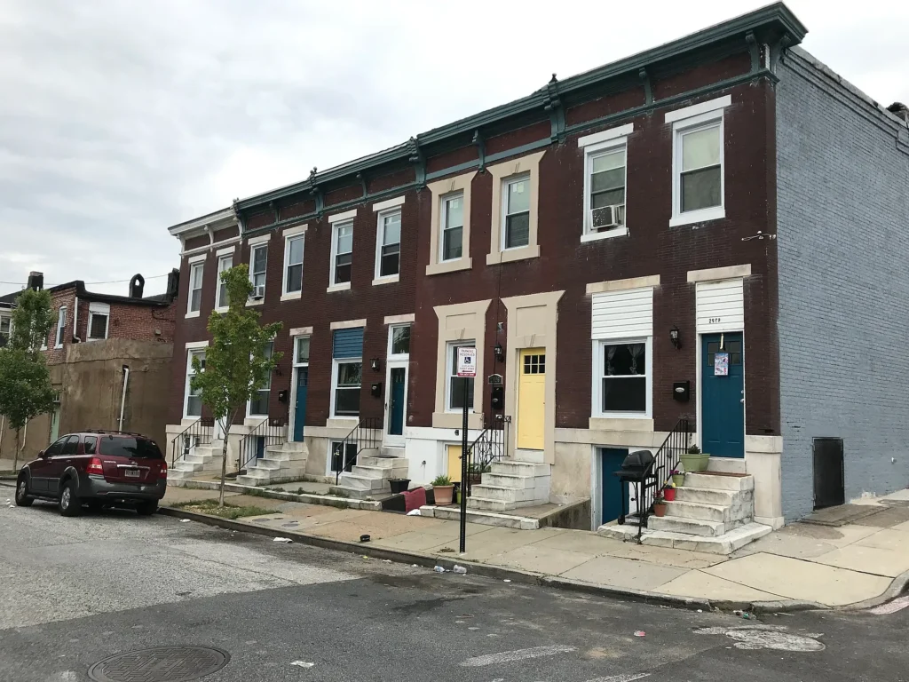 Casas adosadas de ladrillo sobre Pulaski Highway en el este de Baltimore, Maryland, barrio donde se compra placa temporal en Maryland